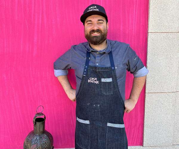Marcos Campos in front of pink wall