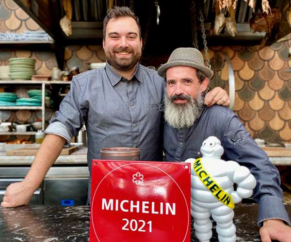 Chefs Marcos and Erwin posing with Michelin Award