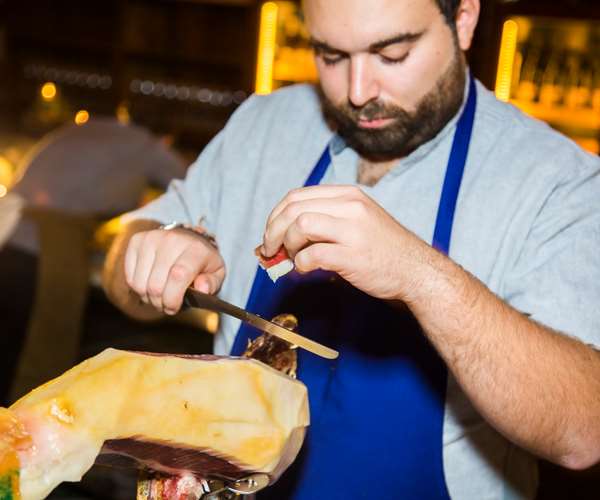 Chef cutting Jamon Iberico