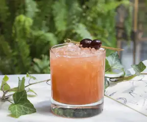 Cocktail garnished with cherries