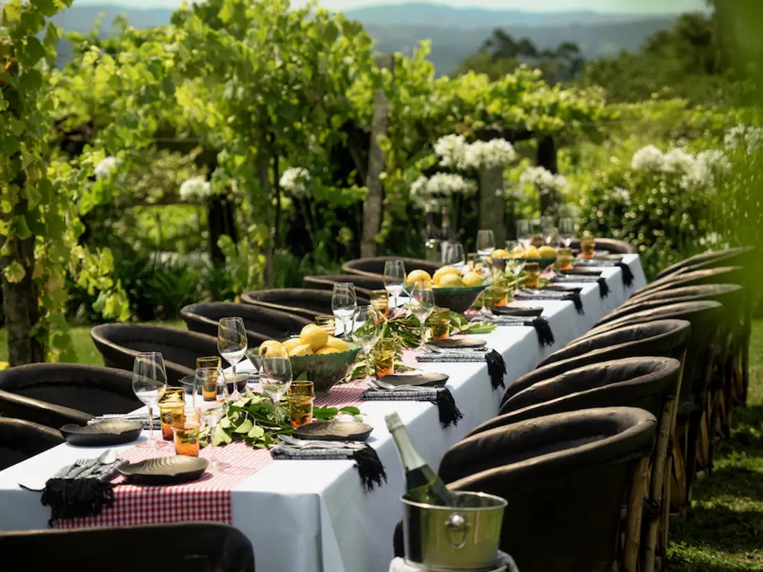 Group table setting in stunning outdoor garden area. 
