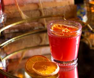 Red cocktail on mirrored table