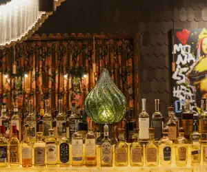 Bar area with liquor bottles at Kashmir. 