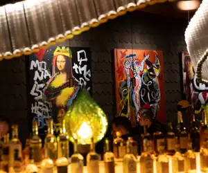 Liquor bottles with art in the background at Kashmir. 