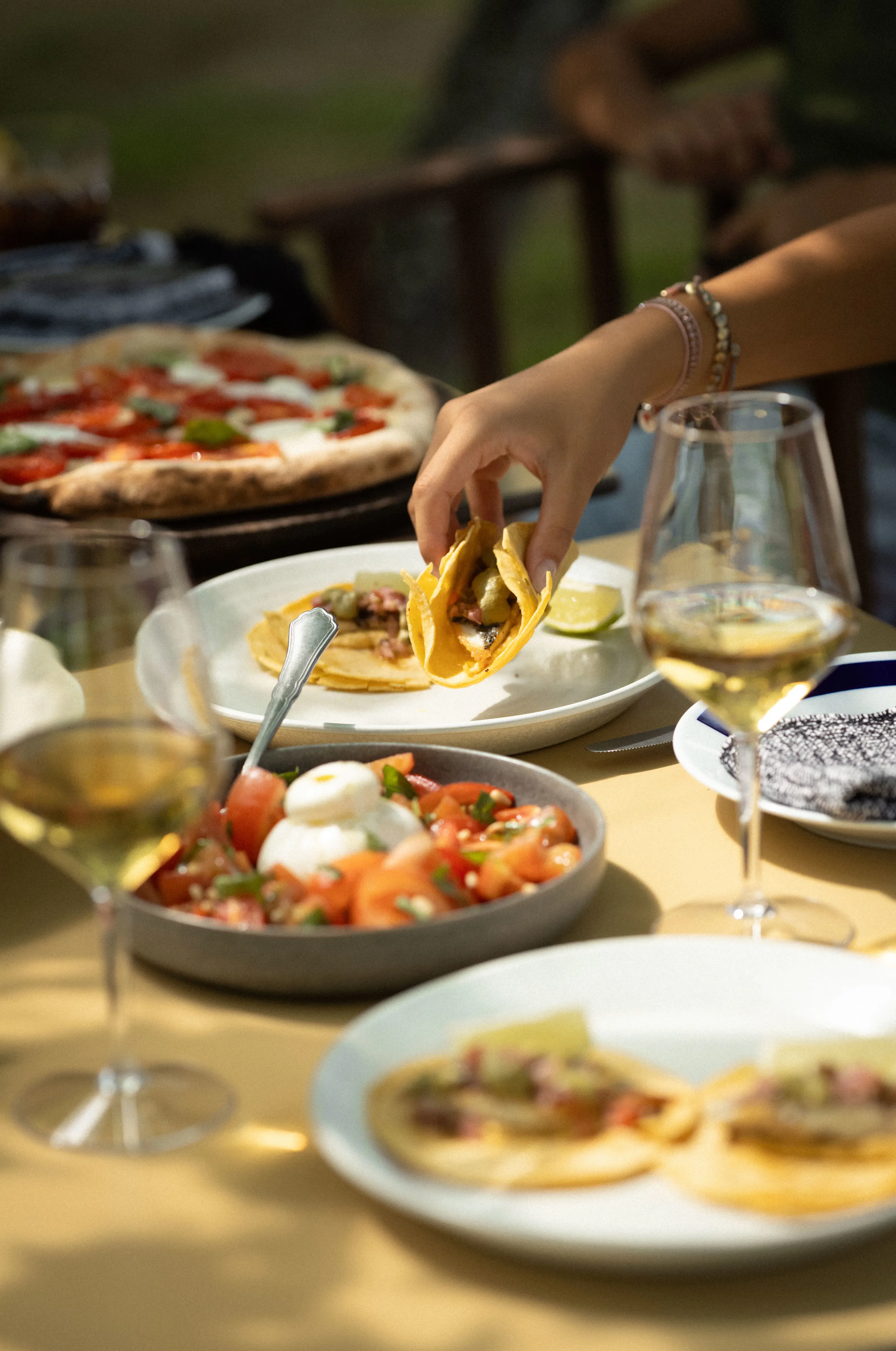 Guests enjoying fresh tacos, tomato salad and wine at Casa Beatnik. 